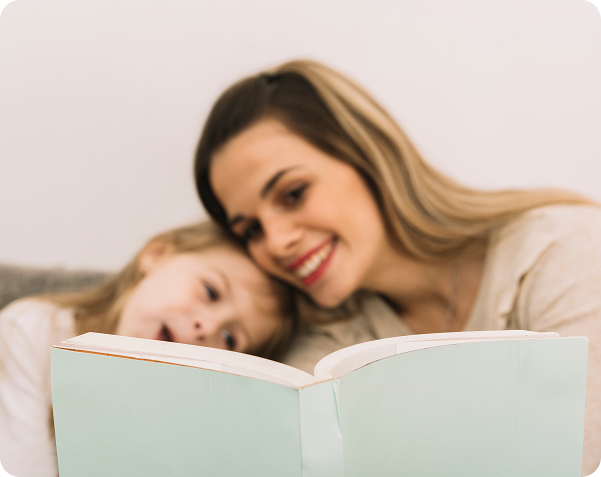 cheerful mother reading book with daughter 1